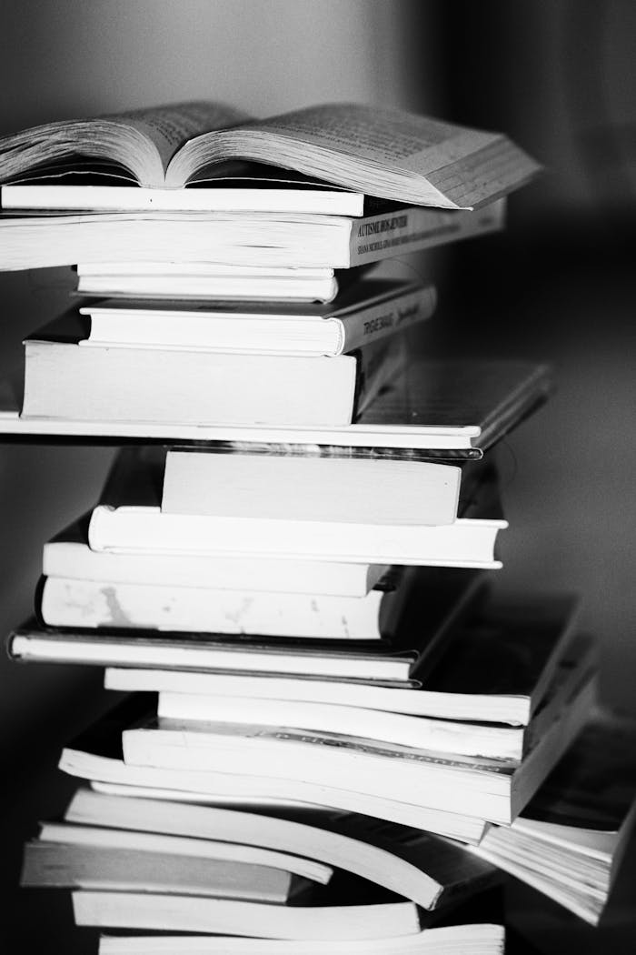 about-01 A monochrome image of a tall stack of books symbolizing education and knowledge.